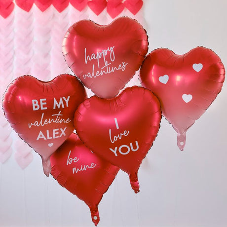Heart-shaped foil balloons in red and ombré, customizable with stickers for Valentine's Day messages.