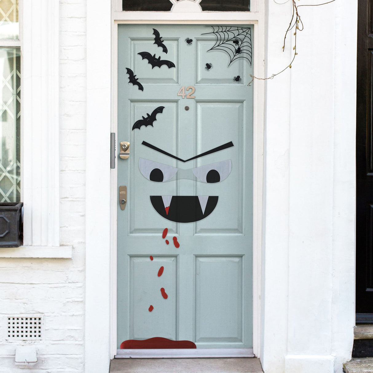 Halloween door stickers featuring a spooky vampire, bats, spiders, and blood drips for a festive decoration.