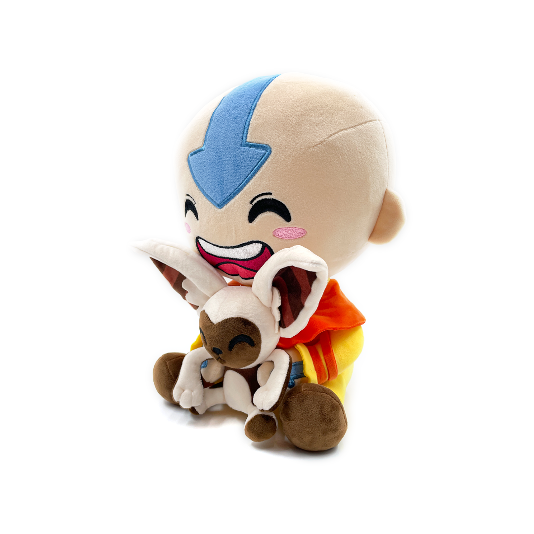 Plush Aang in orange attire joyfully holds Momo, both sitting together, crafted from soft PP cotton for comfort.