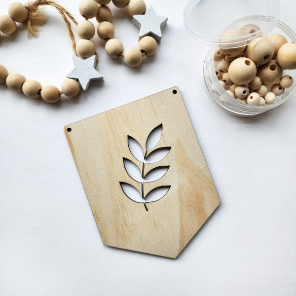 Leaf-patterned Pine Bunting flags made from eco-friendly pine veneer, ideal for festive home decor or events.
