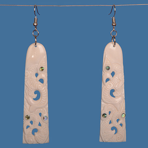Handcrafted Triple Manaia Bone Earring showcasing paua shell accents, symbolizing protection and cultural heritage.