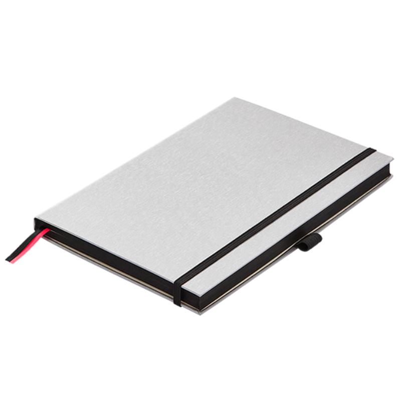 Lamy A5 notebook with silver hard cover, black accents, 192 pages of bleedproof paper, elastic closure, and pen loop.