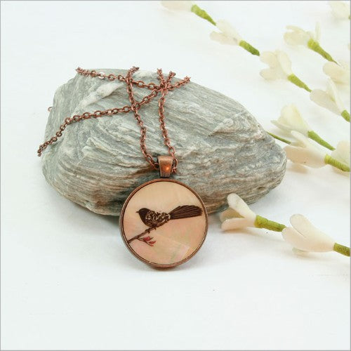 Elegant circle pendant necklace with filigree design, crafted from genuine mother of pearl, 30mm with a 75cm chain.