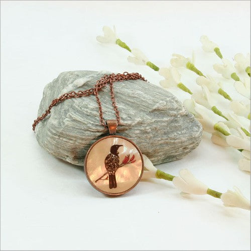 Elegant circle pendant necklace featuring filigree tui design on mother of pearl, with 30mm pendant and 75cm chain.