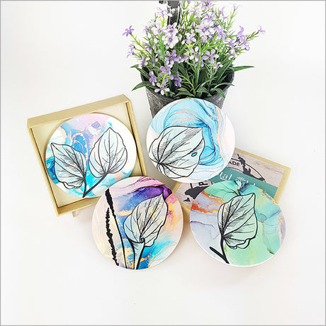 Stylish coasters with Kawakawa leaf designs, featuring durable acrylic and cork base for surface protection.