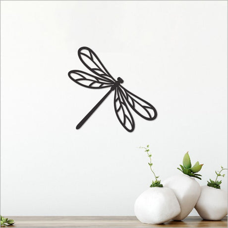 Elegant black acrylic dragonfly wall art, measuring 13.6cm, perfect for enhancing modern interiors with nature-inspired decor.