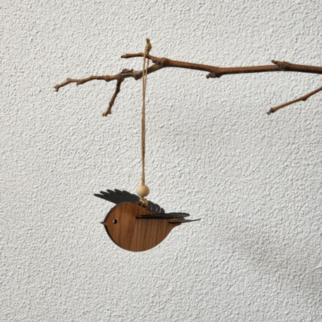 Hanging ornament of a Rimu Robin with 3D wings, crafted from Rimu veneer, ready to hang for nature-themed decor.