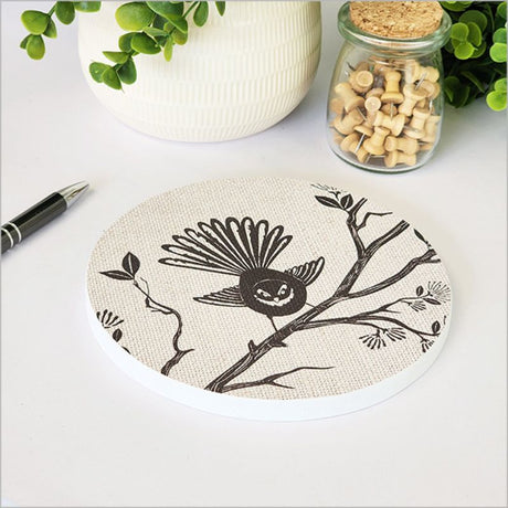Canvas wall art featuring a fantail on a pohutukawa tree, measuring 15cm in diameter, ready to hang.