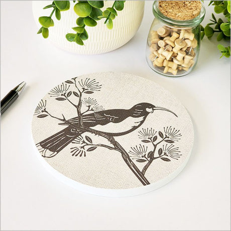 Canvas wall art featuring a Huia bird on a vibrant Pohutukawa tree, 15cm diameter, ready to hang.