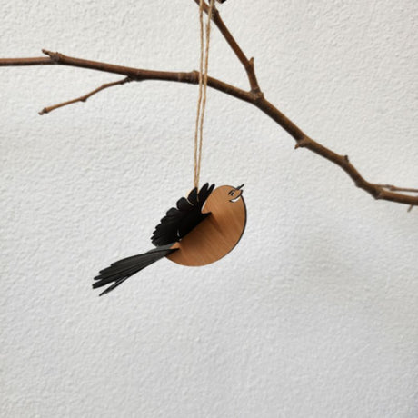 Laser-cut Rimu Fantail ornament with 3D polypropylene wings, perfect for home decor or as a unique gift.