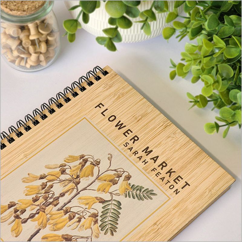 Bamboo journal featuring Kowhai design, 110 pages of 110gsm paper, eco-friendly and versatile for writing and sketching.