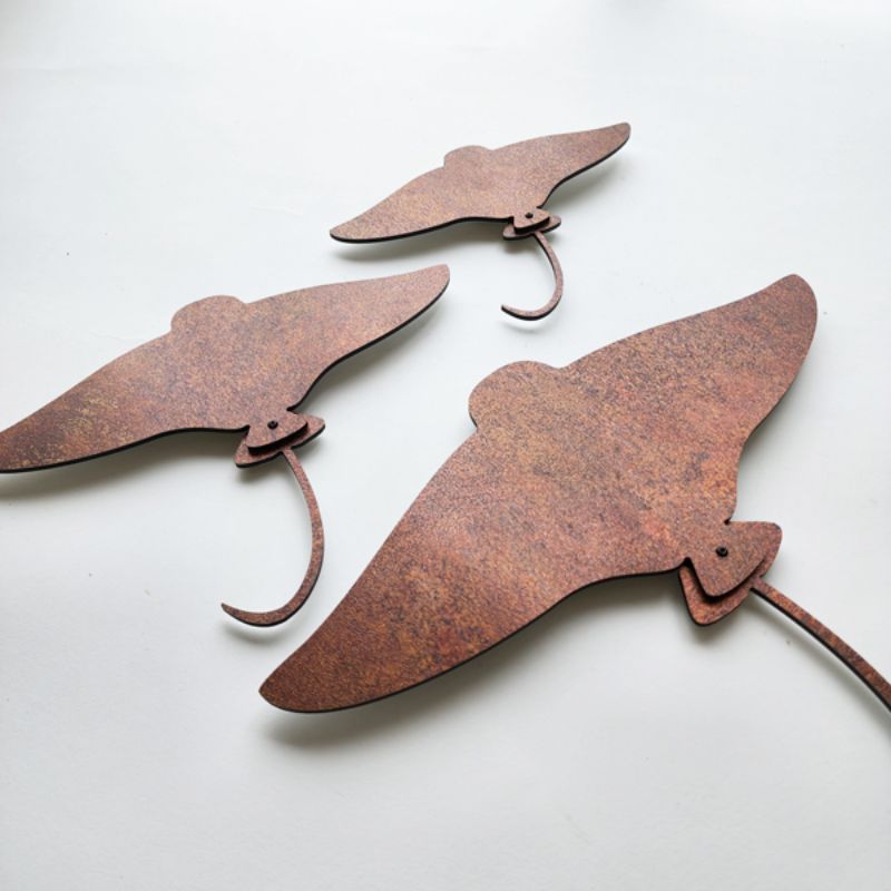 Stunning rusted copper wall art set featuring elegant stingray designs, perfect for modern interior decor.