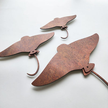 Stunning rusted copper wall art set featuring elegant stingray designs, perfect for modern interior decor.
