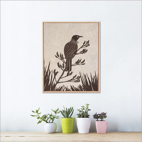 Framed canvas art features a vibrant Tui bird on Flax, perfect for enhancing home decor with nature-inspired beauty.