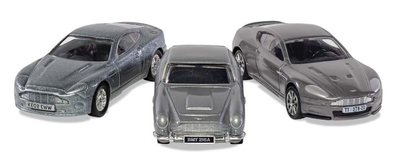 Diecast collection of iconic James Bond Aston Martins: V12 Vanquish, DB5 with BMT 216A plate, and luxurious DBS models.