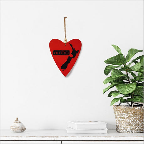 Stylish black Kiwiana wall art featuring a heart shape symbolizing Aroha, measuring 230mm x 270mm, ready to hang.