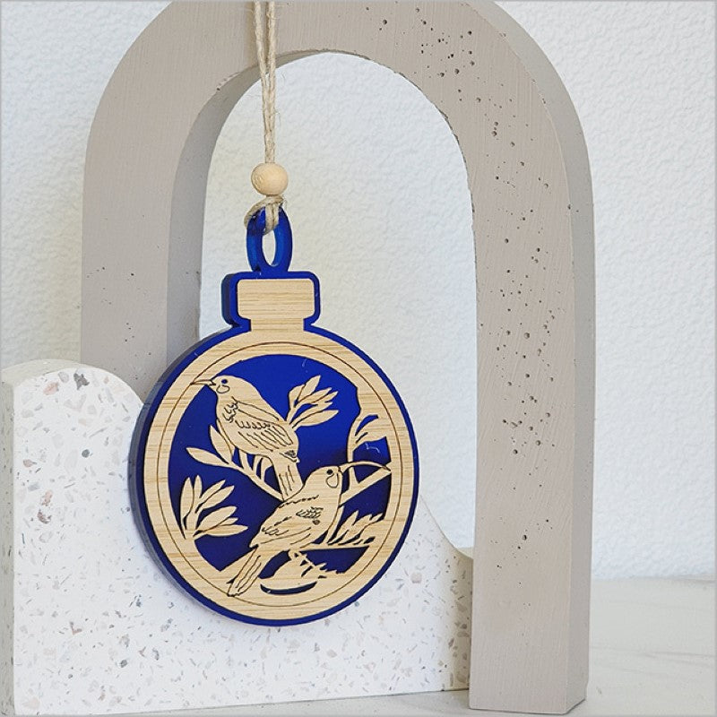 Elegant blue satin acrylic bauble featuring a Huia bird design, perfect for festive decor or gifting.
