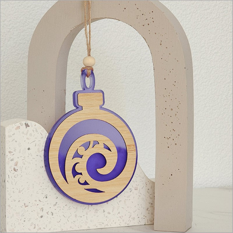 Purple satin acrylic hanging ornament featuring a unique Koru design, symbolizing growth and new beginnings.