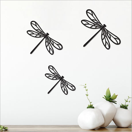 Acrylic wall art set featuring three matte black dragonflies, perfect for modern and minimalist home decor.