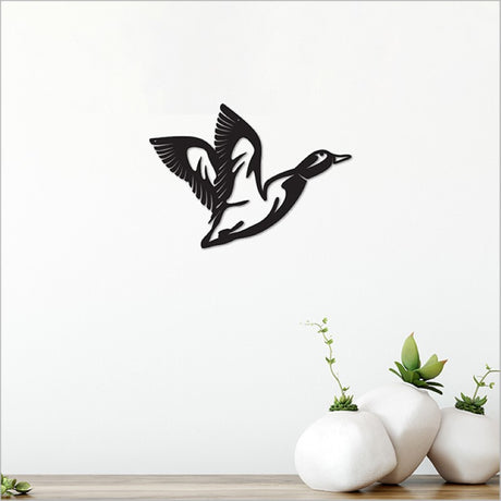 Acrylic wall art featuring a sleek black flying duck, perfect for modern home decor, measuring 22cm.
