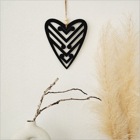 Black acrylic heart wall art featuring five koru designs, symbolizing new beginnings, perfect for home decor.