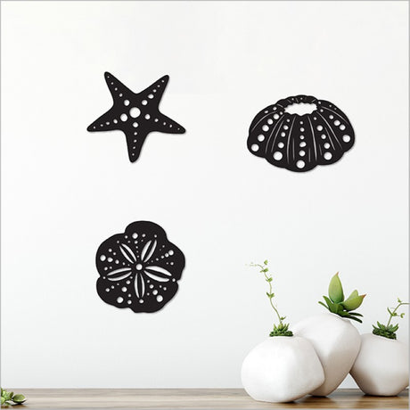 Acrylic wall art set featuring intricate black sea life designs, perfect for marine-themed decor in any space.