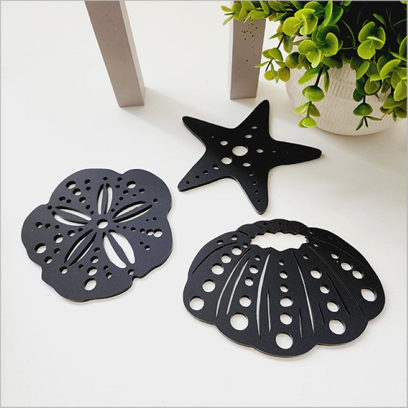 Acrylic wall art set featuring intricate black sea life designs including kina and starfish, perfect for marine decor.