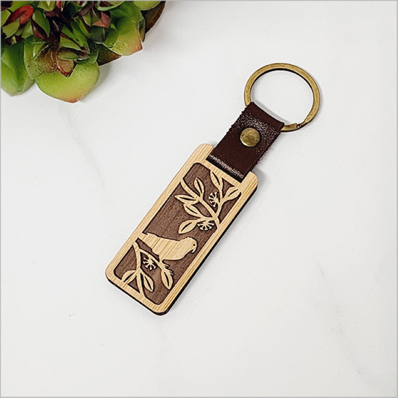 Eco-friendly bamboo keyring showcasing Kiwiana style, laser-cut and lightweight for practical use and unique gifting.