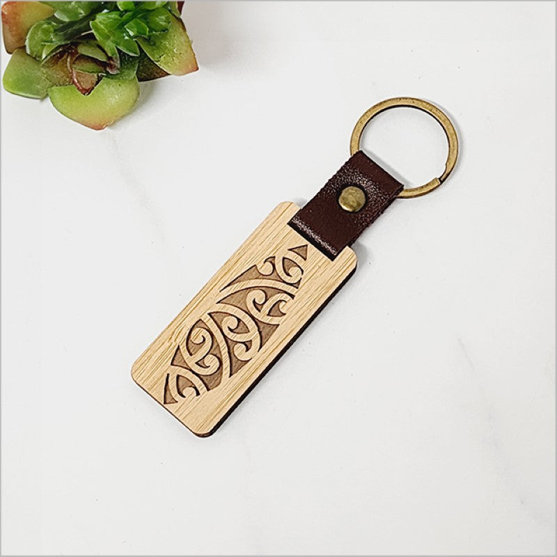 Eco-friendly bamboo keyring with Kiwiana charm, measuring 28mm x 64mm, perfect for stylish key organization.