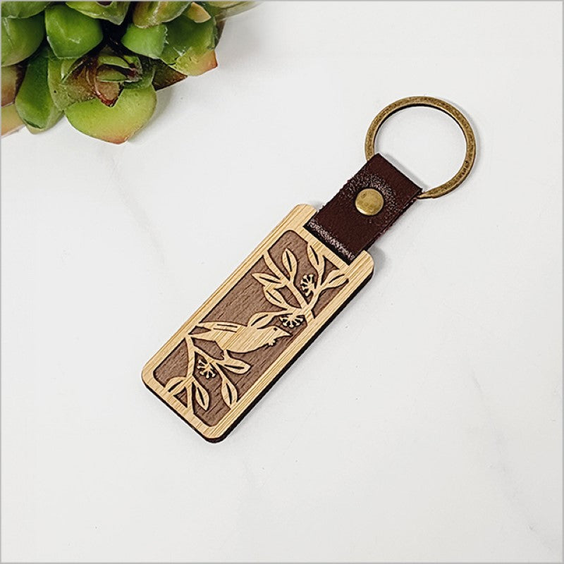 Eco-friendly bamboo keyring featuring a laser-cut Tui design, perfect for keys and Kiwiana-inspired gifts.
