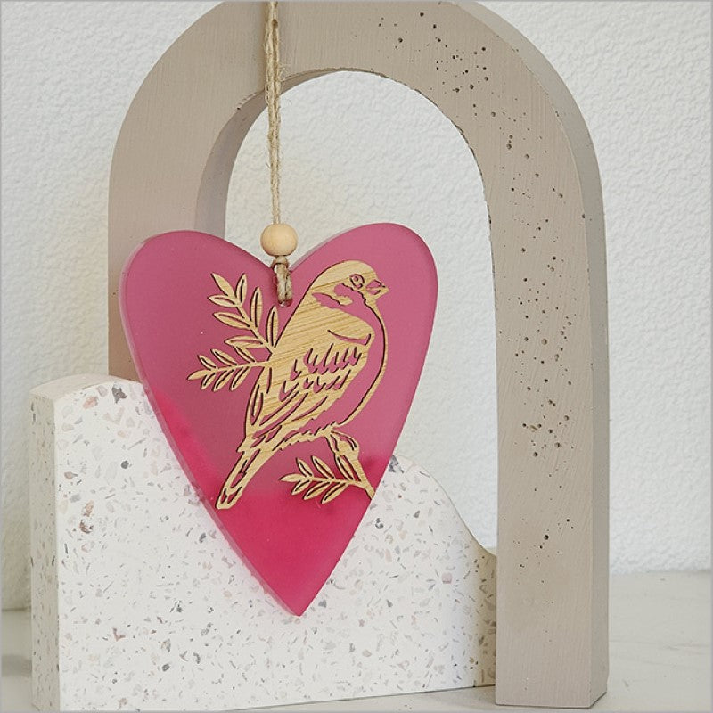 Heart-shaped pink satin acrylic hanging ornament featuring sparrow and pihoihoi designs, perfect for home decor or gifting.