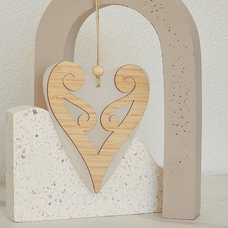 Elegant white satin acrylic heart ornament featuring a Koru design, perfect for modern decor or thoughtful gifts.