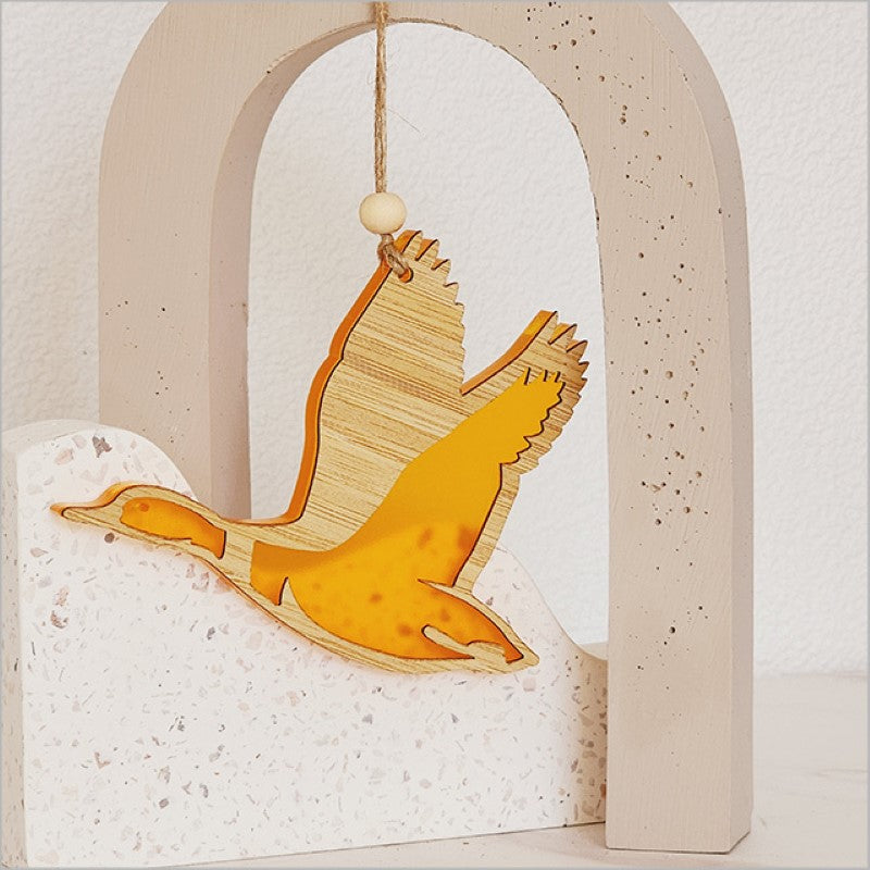 Vibrant orange acrylic duck ornament, laser cut from bamboo, perfect for adding festive charm to your holiday decor.