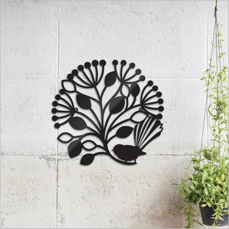 Black circular wall art featuring a fantail bird and Pohutukawa tree, crafted from durable Aluminium Composite Material.