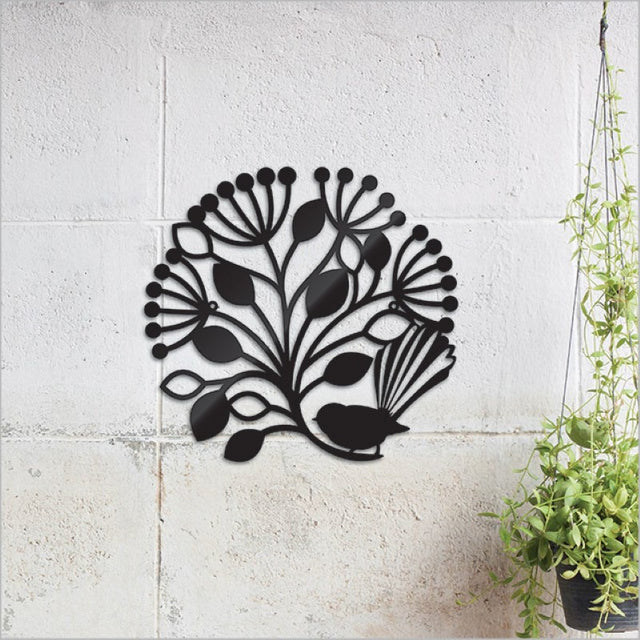 Black circular wall art featuring a fantail bird and Pohutukawa tree, crafted from durable Aluminium Composite Material.