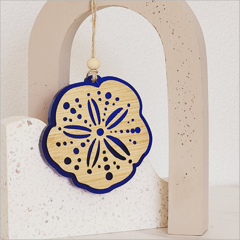 Acrylic Kina ornament in blue satin, featuring a unique laser-cut bamboo design, perfect for holiday decor.