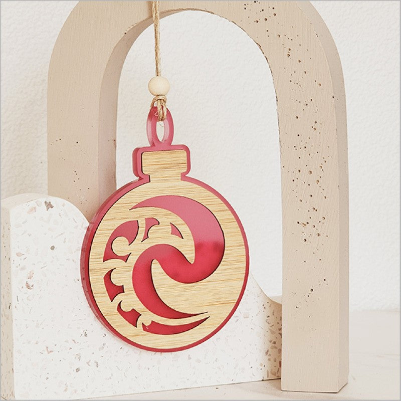 Pink satin acrylic hanging ornament featuring the Koru design, symbolizing growth, perfect for festive decor.