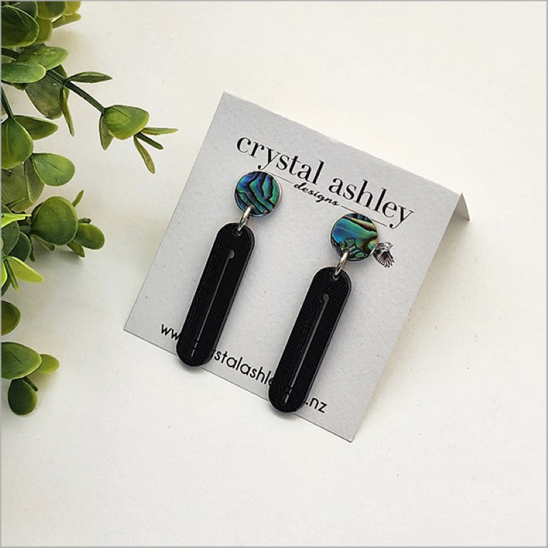 Long drop earrings featuring black wharare and unique paua shell, inspired by New Zealand's natural beauty.