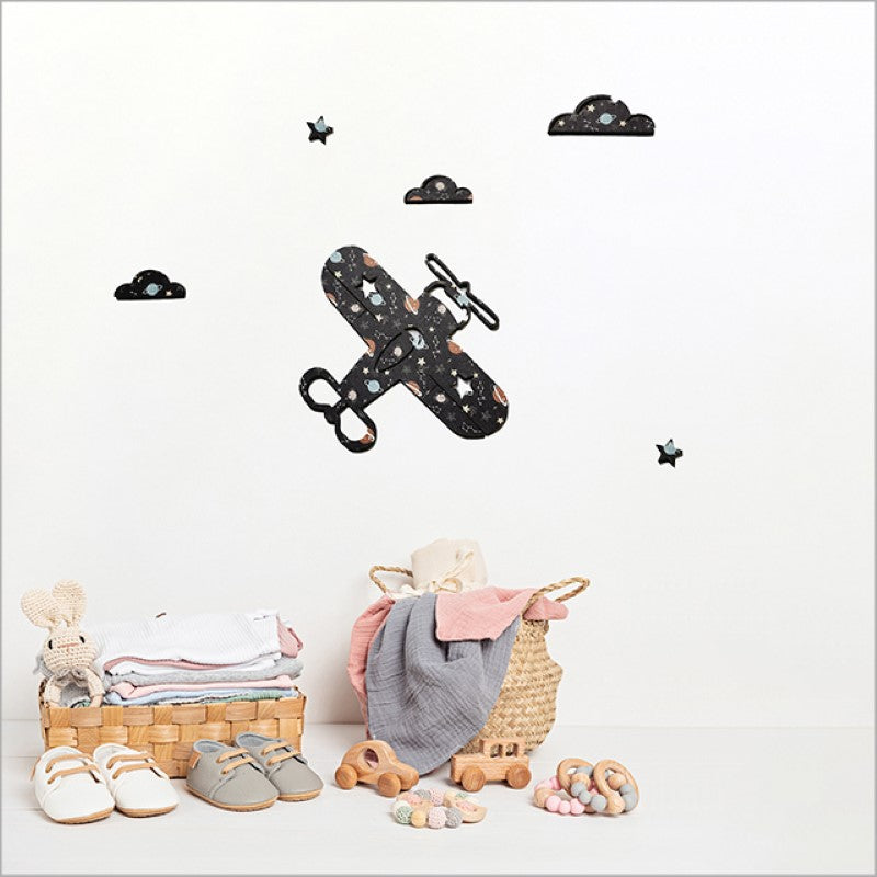 Textured wall art featuring a propeller plane, clouds, and stars against a night sky for children's rooms.