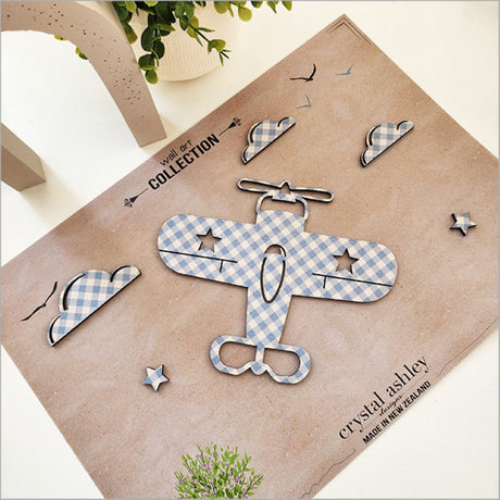 Whimsical nursery wall art featuring a textured blue check propeller plane, clouds, and stars for charming decor.