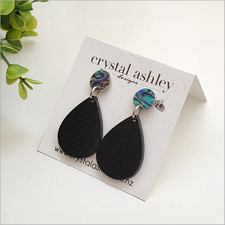 Teardrop earrings crafted from Black Wharare wood and vibrant Paua shell, showcasing unique Kiwiana elegance.