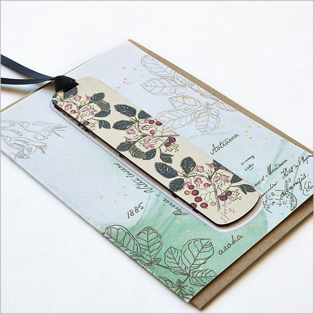 Greeting card featuring Sarah Featon's Puriri watercolor art with a bamboo bookmark, showcasing New Zealand's flora.