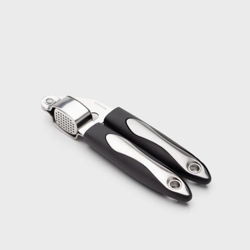 Taylors Garlic Press crushes unpeeled cloves effortlessly for rich, fresh flavor in your dishes.