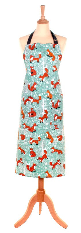 Ulster Weavers Cotton Foraging Fox apron featuring a whimsical fox design and duck egg shell background, with adjustable ties and pocket.