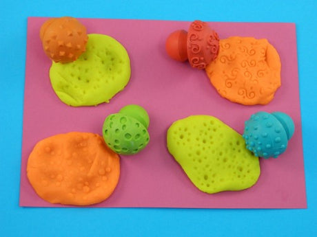 Set of 4 child-friendly hemispherical stampers with fun patterns for creative art projects and skill development.