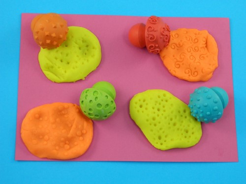 Set of 4 child-friendly hemispherical stampers with fun patterns for creative art projects and skill development.