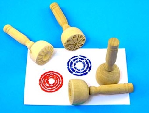 Wooden paint and clay stampers for kids featuring four unique designs, perfect for enhancing creativity in arts and crafts.