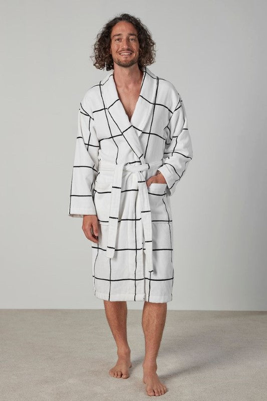 Luxurious white velour bathrobe with large check design, shawl collar, pockets, and waist tie for ultimate comfort.