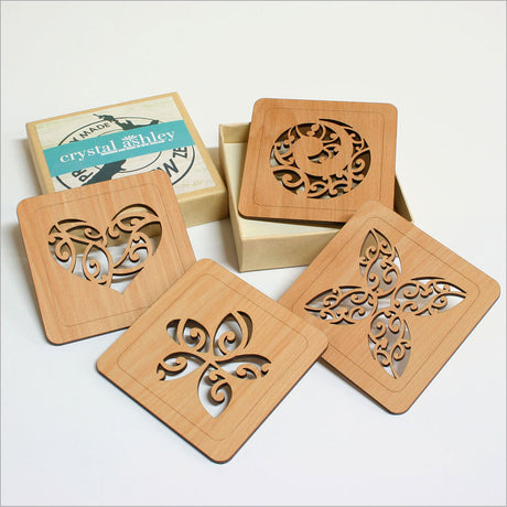 Handcrafted rimu wood coasters featuring intricate Kowhaiwhai designs, perfect for protecting surfaces and adding elegance.
