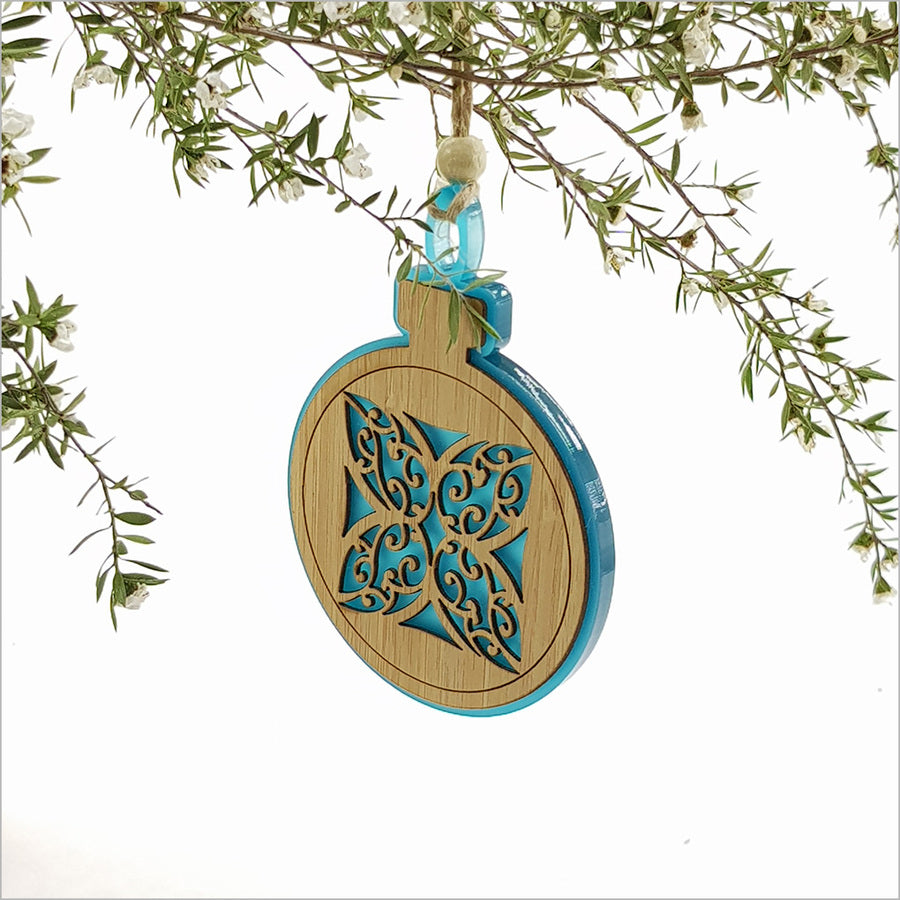 Teal satin acrylic bauble ornament with Kww flower design, perfect for holiday decor or gifting, measuring 80mm x 110mm.